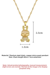 Close-up of gold rabbit pendant with cat eye stone and cubic zirconia on a titanium chain