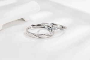 Detail of adjustable couple rings with diamond-set woman band and textured man ring