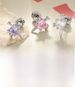 Detail showing heart zircon screw back earrings in purple, pink and white silver finish