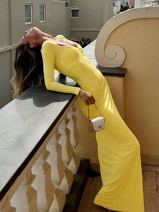 Elegant long sleeve slim fit maxi dress in bright yellow with a low cut U-shaped neckline