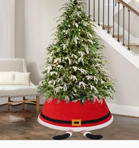 Detailed red fabric Christmas tree skirt featuring Santa legs and belt in a cozy home setting