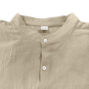 Dettaglio camicia in cotone kaki con collo alla coreana e trama naturale dei bottoni