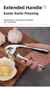 Macro shot of stainless steel garlic press with extended handles squeezing fresh garlic