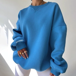 Oversized blue knit crewneck sweatshirt with long sleeves and ribbed cuffs for women