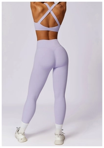 Detail of lavender high-waist yoga leggings and cross-back sports bra with moisture-wicking fabric