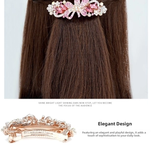 Close-up of pink crystal flower hair clip with spring barrette on long brown hair