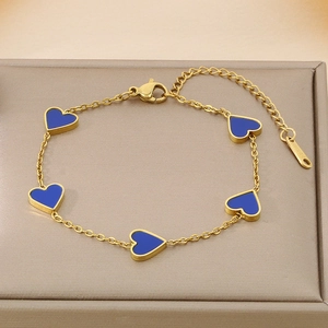 Detail of gold stainless steel bracelet featuring five blue enamel hearts and lobster clasp
