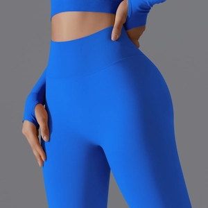 Detail of high waisted compression yoga pants and long sleeve top in bright blue