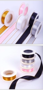 Detailed view of assorted satin ribbons with gold edges in various elegant colors