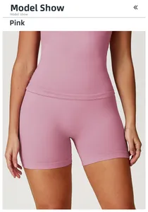 Detail of high-waist seamless dusty pink yoga shorts featuring ribbed knit texture