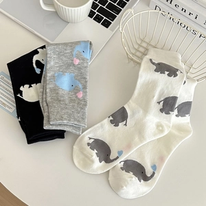 Detailed view of cotton socks with cartoon elephant patterns in black, grey, and white colors