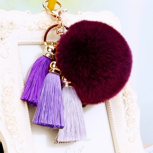 Burgundy plush faux fur pompom keychain with purple silk tassels and gold alloy hardware