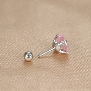 Close-up of a pink heart-shaped zircon ear stud with silver titanium steel ball back