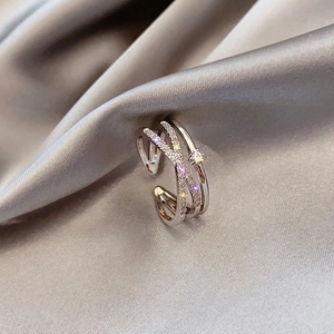 Detailed view of layered criss-cross silver ring with micro-paved sparkling zircons