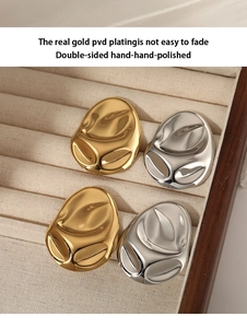Detail of PVD gold plated irregular wavy earrings with double-sided hand polishing