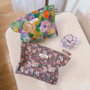 Floral cotton cosmetic bags with vintage prints and simple wish label on white tray