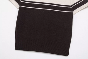 Detailed close-up showing the premium ribbed knit texture of the black and white polo shirt