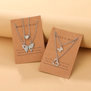 Detail view of silver split butterfly and heart magnetic necklaces on wish cards