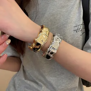 Irregular wavy texture horseshoe buckle open bangle in gold and silver finish