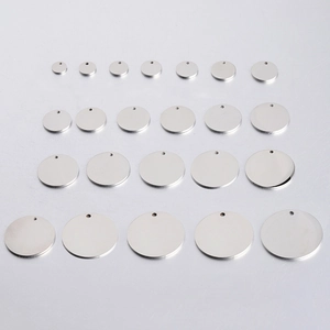 Collection of mirror-polished titanium steel round tags in various sizes for DIY jewelry