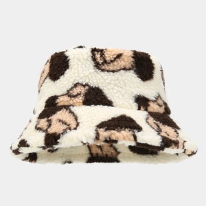 Detailed close-up of fluffy faux lamb wool bucket hat with stylish animal print pattern
