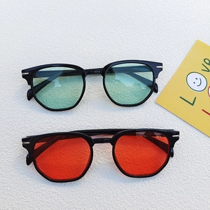 Vintage retro sunglasses with thick black frames and colorful red and green lenses