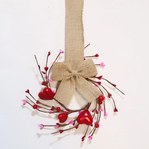Valentine's berry candle ring with red hearts and burlap bow on wooden base