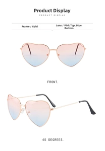 Detail view of heart-shaped metal sunglasses with gold frame and pink-blue gradient lenses