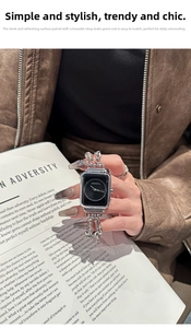 Detail view of silver stainless steel chain link strap on a sleek smartwatch