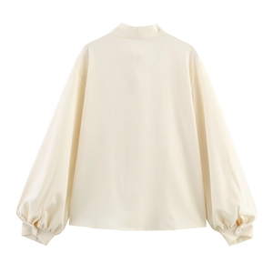 Back view of elegant beige lantern sleeve blouse with lace stitching and stand collar