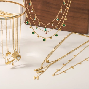 Gold-plated stainless steel layered necklace set with heart pendants and colorful gems