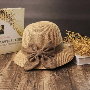 Straw sun hat for women with bow decoration in a summer vacation bucket hat style