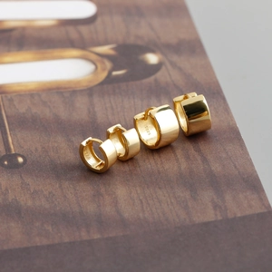 Detailed view of graduated size S925 sterling silver gold plated hoop earrings set