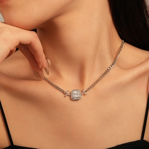 Macro shot of silver clavicle necklace featuring a radiant-cut square zircon pendant