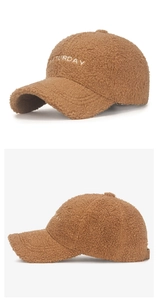 Detailed close-up of brown Sherpa baseball cap with white SATURDAY embroidery detail