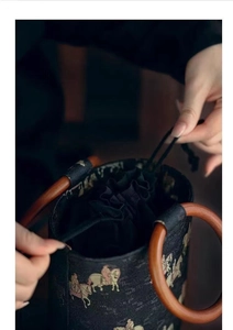 Detail of drawstring closure and wooden ring handle on Chinese style bucket bag