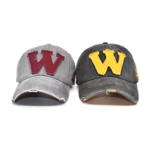 Detail of distressed vintage baseball caps with felt W patches and frayed brim edges