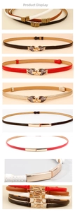 Detail view of thin faux leather belts with various gold buckles and multiple colors