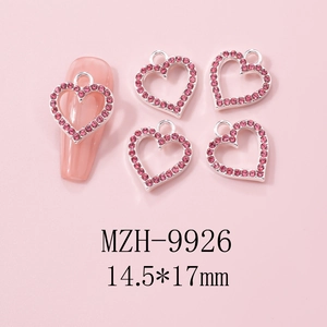 Detail of silver alloy heart nail charms with pink rhinestones for Y2K nail art designs