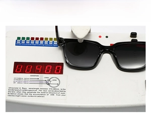 UV400 protection test showing black square sunglasses on a professional testing device