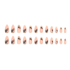 Almond press-on nails with minimalist black leaf patterns and gold foil on nude base