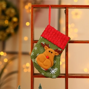 Christmas stocking with brown reindeer and white snowflakes hanging on a wooden frame