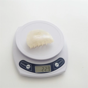 Creamy white marble pattern acetate hair claw clip weighing 22.9g on a scale