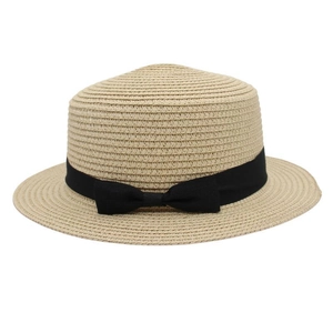 Detailed close-up of a beige straw boater hat featuring a black ribbon bow decoration