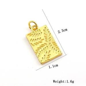 Detail view of a gold rectangular pendant with leaf relief texture and size measurements