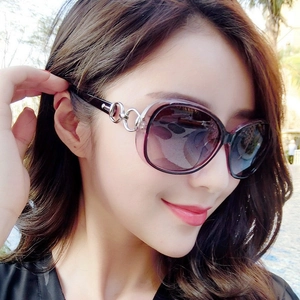 Close-up of oversized gradient purple sunglasses with silver metal ring on the temple