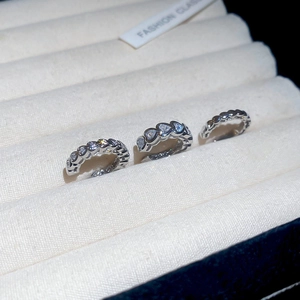 Detailed view of silver heart-shaped ear cuffs set with sparkling cubic zirconia stones