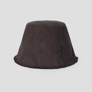 Close-up of brown corduroy bucket hat with fringe brim and black logo fabric label