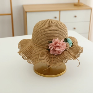 Detailed weave of kids straw hat with floral lace brim and fabric flower accents