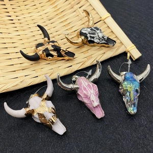Bull skull stone acrylic pendants in five colors displayed on a bamboo tray